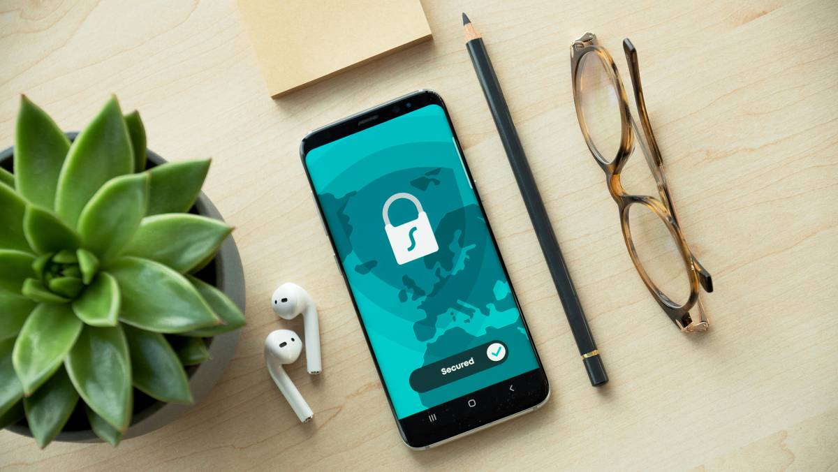 A laptop displaying encrypted files next to a smartphone with a lock icon, illustrating Encryption Tools protecting telecom data