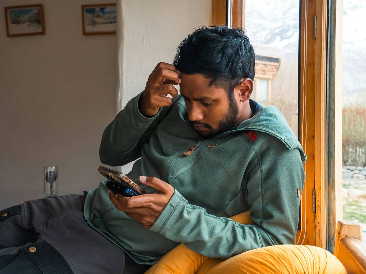 Person frustrated at laptop during telecommunications outage today with router lights off